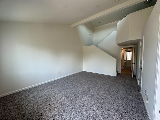 bonus room with vaulted ceiling, dark colored carpet, and baseboards