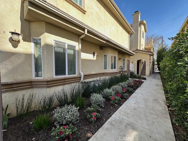 view of home's exterior with stucco siding and a chimney