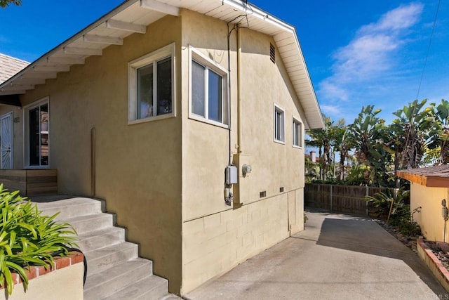 1855 Rubenstein Dr, Cardiff By The Sea, CA 92007 - view of side of property featuring fence, stucco siding, and a patio