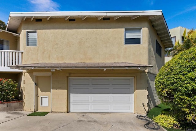 1855 Rubenstein Dr, Cardiff By The Sea, CA 92007 - view of property with concrete driveway, a garage, concrete block siding, and stucco siding