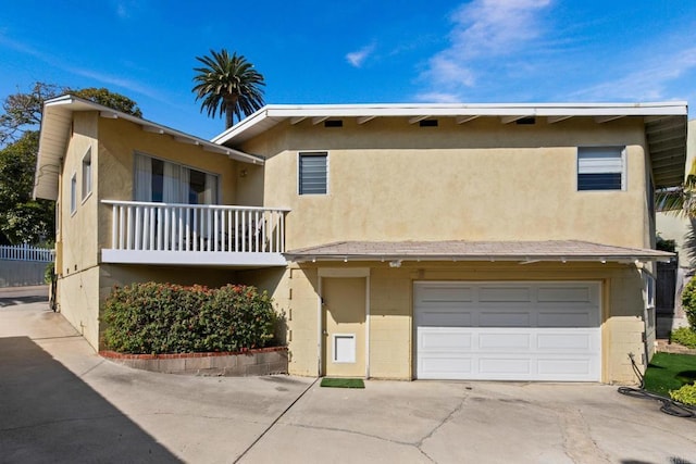 1855 Rubenstein Dr, Cardiff By The Sea, CA 92007 - view of property featuring driveway, an attached garage, stucco siding, and concrete block siding