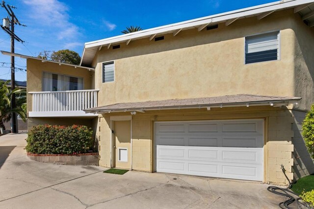 1855 Rubenstein Dr, Cardiff By The Sea, CA 92007 - view of front of property featuring concrete driveway, an attached garage, a balcony, and stucco siding