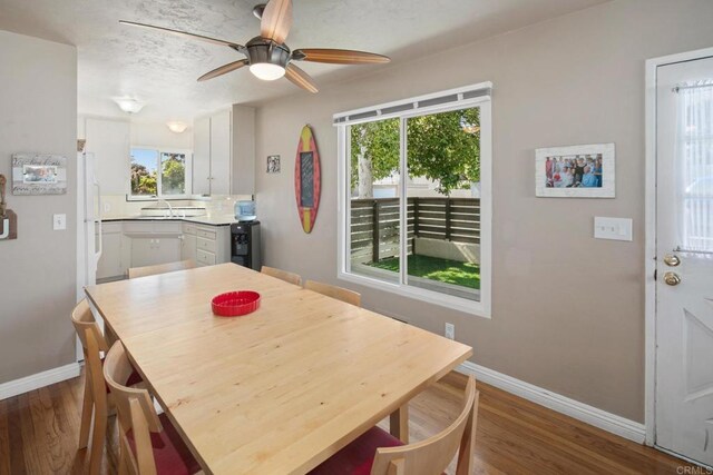 1855 Rubenstein Dr, Cardiff By The Sea, CA 92007 - dining room featuring baseboards, healthy amount of natural light, wood finished floors, and ceiling fan