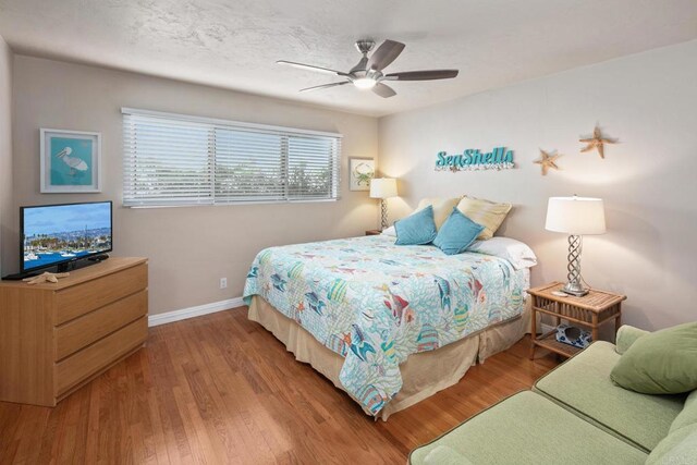 1855 Rubenstein Dr, Cardiff By The Sea, CA 92007 - bedroom featuring baseboards, wood finished floors, and ceiling fan