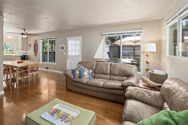 1855 Rubenstein Dr, Cardiff By The Sea, CA 92007 - living room featuring wood finished floors, plenty of natural light, baseboards, and ceiling fan