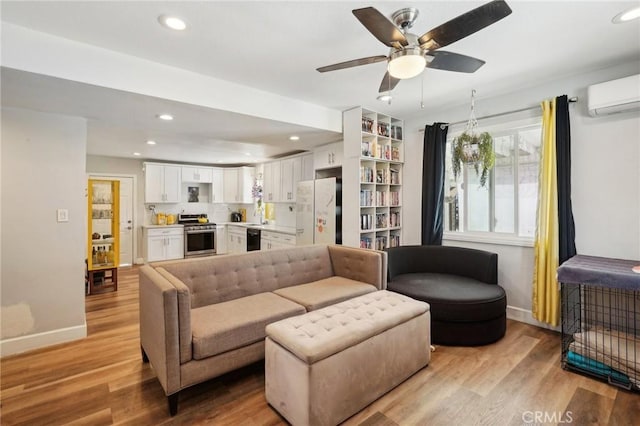1109 S Dacotah St, Los Angeles, CA 90023 - living room featuring a wall mounted AC, light wood-type flooring, plenty of natural light, and recessed lighting