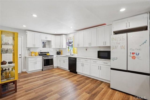 1109 S Dacotah St, Los Angeles, CA 90023 - kitchen featuring black appliances, white cabinetry, light countertops, tasteful backsplash, and recessed lighting
