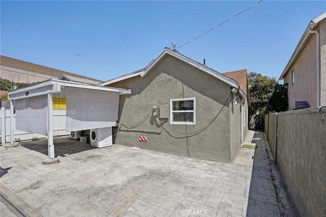 1109 S Dacotah St, Los Angeles, CA 90023 - back of house featuring a patio area, a fenced backyard, stucco siding, and ac unit