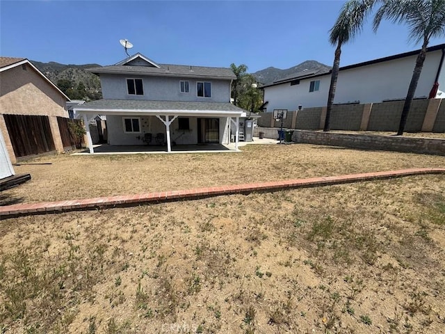 13278 Parkland Cir, Sylmar, CA 91342 - back of house featuring a patio area, a fenced backyard, stucco siding, and a mountain view