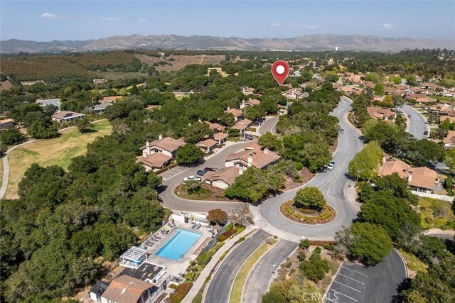 1334 Tourney Hill Ln Unit 61, Nipomo, CA 93444 - aerial view of property and surrounding area with mountains and a pool area