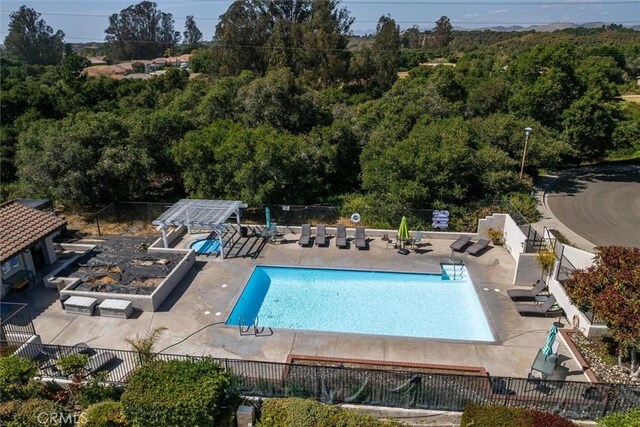 1334 Tourney Hill Ln Unit 61, Nipomo, CA 93444 - community pool featuring fence, a patio area, and a forest view