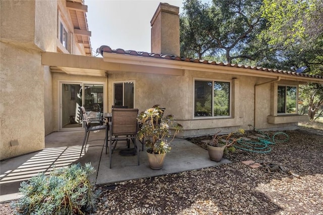 1334 Tourney Hill Ln Unit 61, Nipomo, CA 93444 - back of property featuring a patio area, stucco siding, and a chimney