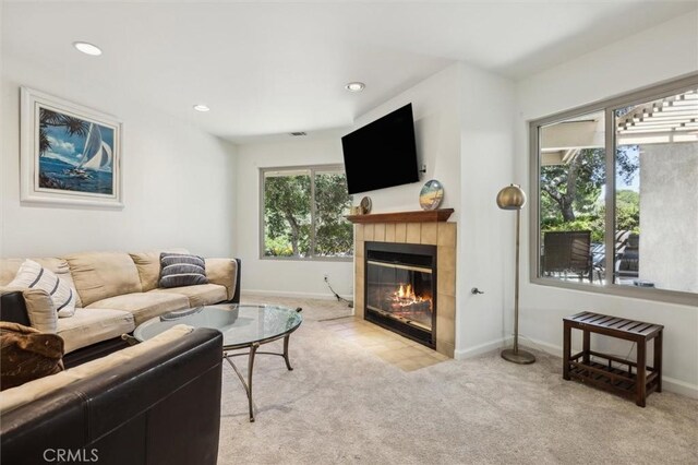 1334 Tourney Hill Ln Unit 61, Nipomo, CA 93444 - living room with light colored carpet, a tiled fireplace, baseboards, and recessed lighting