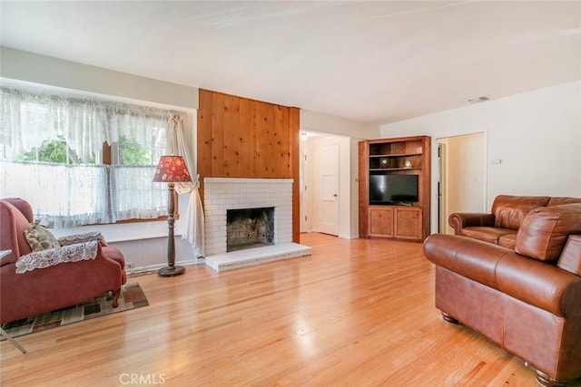14719 Wyandotte St, Van Nuys, CA 91405 - living area with light wood finished floors and a brick fireplace