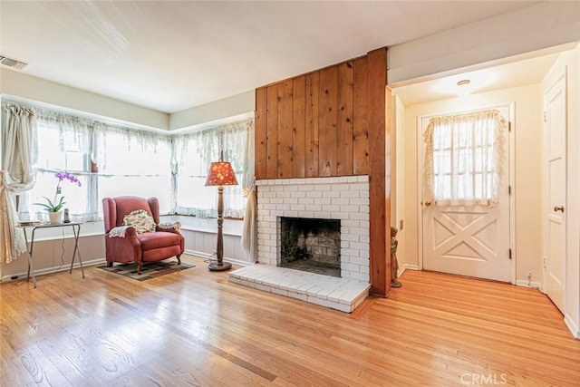 14719 Wyandotte St, Van Nuys, CA 91405 - living area with light wood-style flooring, a fireplace, and baseboards