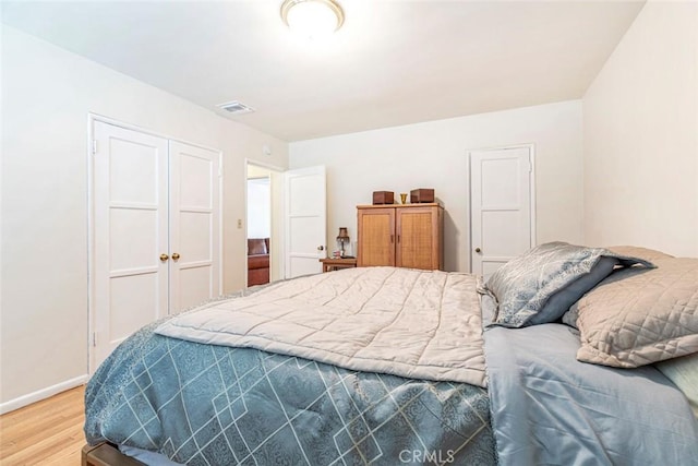 14719 Wyandotte St, Van Nuys, CA 91405 - bedroom with light wood-type flooring, a closet, and baseboards