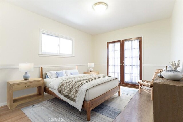 14719 Wyandotte St, Van Nuys, CA 91405 - bedroom with multiple windows, french doors, and light wood-type flooring