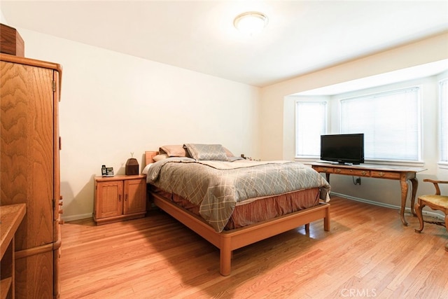 14719 Wyandotte St, Van Nuys, CA 91405 - bedroom with light wood-style floors, multiple windows, and baseboards