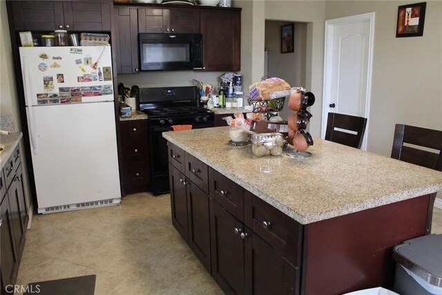 975 E Citrus St, Riverside, CA 92507 - kitchen featuring black appliances, a kitchen island, dark brown cabinetry, and light floors