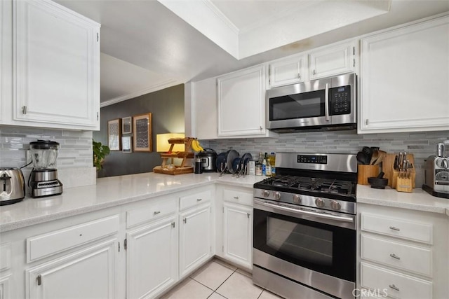 4455 Fulton Ave Unit 2, Sherman Oaks, CA 91423 - kitchen with stainless steel appliances, ornamental molding, tasteful backsplash, and white cabinetry
