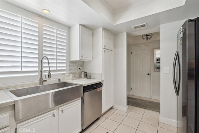 4455 Fulton Ave Unit 2, Sherman Oaks, CA 91423 - kitchen with stainless steel appliances, a sink, light tile patterned floors, white cabinets, and ornamental molding