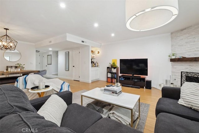 4455 Fulton Ave Unit 2, Sherman Oaks, CA 91423 - living room featuring light wood-style flooring, recessed lighting, a chandelier, ornamental molding, and a fireplace