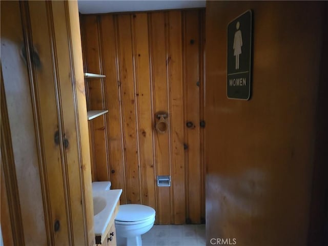 29348 123rd St E, Pearblossom, CA 93553 - bathroom featuring toilet and wood walls
