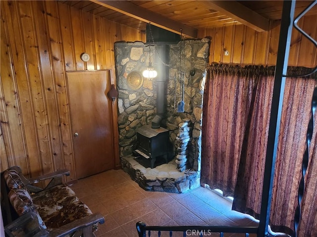 29348 123rd St E, Pearblossom, CA 93553 - bathroom featuring wood walls, a wood stove, wood ceiling, tile patterned flooring, and beam ceiling