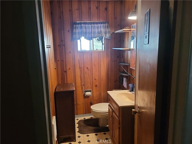 29348 123rd St E, Pearblossom, CA 93553 - bathroom with wooden walls, toilet, vanity, and tile patterned floors