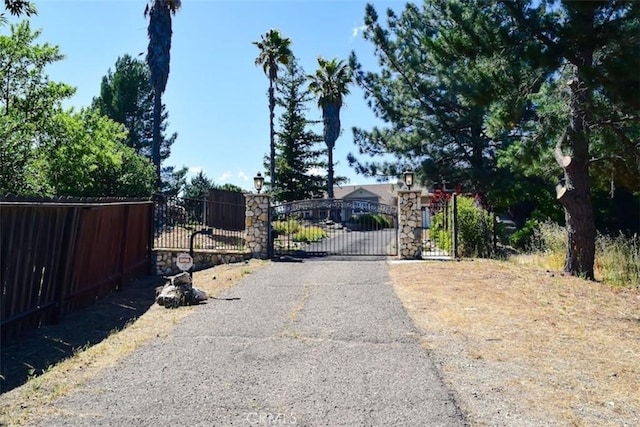 5 W 12th St, Paso Robles, CA 93446 - view of asphalt road featuring a gate and street lights