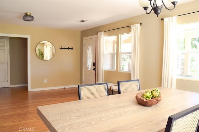5 W 12th St, Paso Robles, CA 93446 - dining area featuring light wood-style floors, plenty of natural light, a chandelier, and baseboards
