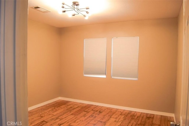 5 W 12th St, Paso Robles, CA 93446 - unfurnished room featuring a chandelier, wood finished floors, and baseboards