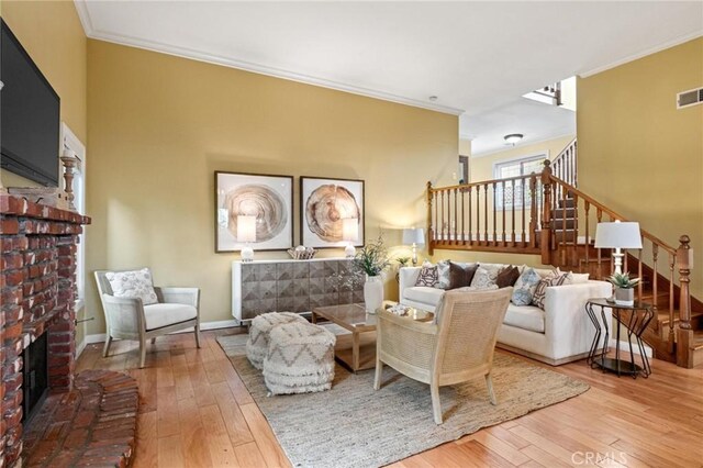 1909 Belmont Ln Unit B, Redondo Beach, CA 90278 - living room featuring a brick fireplace, stairway, hardwood / wood-style floors, crown molding, and baseboards