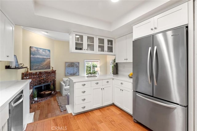1909 Belmont Ln Unit B, Redondo Beach, CA 90278 - kitchen with stainless steel fridge, light countertops, glass insert cabinets, light wood-type flooring, and crown molding