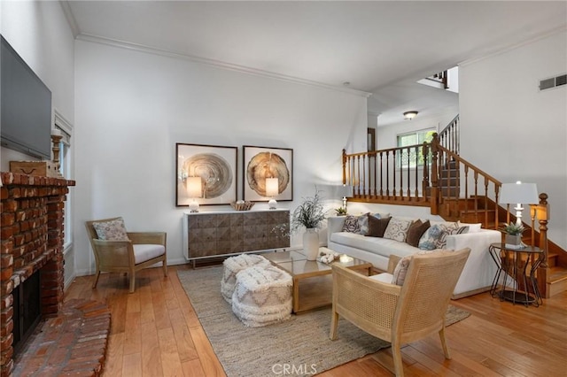 1909 Belmont Ln Unit B, Redondo Beach, CA 90278 - living area featuring hardwood / wood-style flooring, crown molding, stairway, and a fireplace