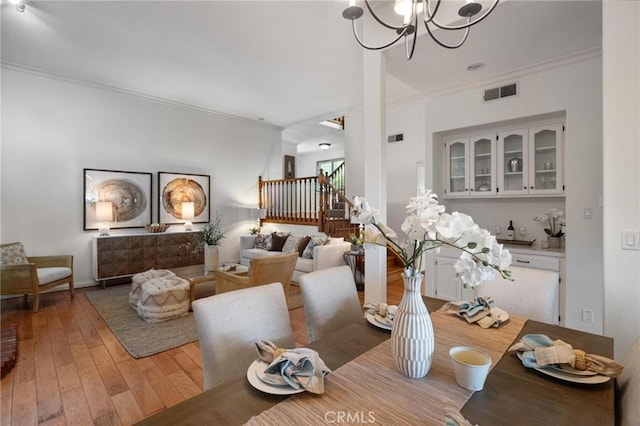 1909 Belmont Ln Unit B, Redondo Beach, CA 90278 - dining room featuring a chandelier, stairway, crown molding, and light wood finished floors