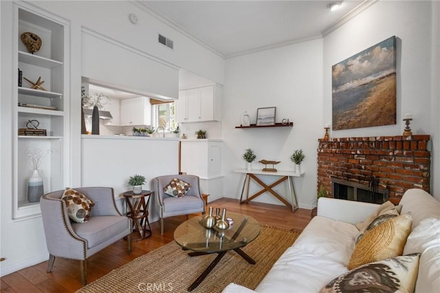 1909 Belmont Ln Unit B, Redondo Beach, CA 90278 - living room with wood finished floors, ornamental molding, and a brick fireplace