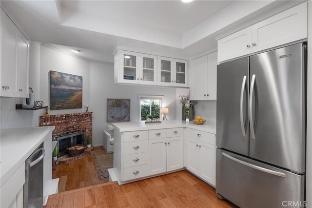 1909 Belmont Ln Unit B, Redondo Beach, CA 90278 - kitchen with appliances with stainless steel finishes, light countertops, light wood finished floors, and glass insert cabinets