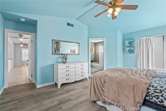 23633 Breezy Meadow Ct, Moreno Valley, CA 92557 - bedroom featuring vaulted ceiling, wood finished floors, baseboards, connected bathroom, and ceiling fan
