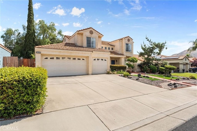 23633 Breezy Meadow Ct, Moreno Valley, CA 92557 - mediterranean / spanish home featuring stucco siding, concrete driveway, fence, a tile roof, and a garage