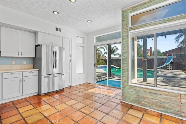 23633 Breezy Meadow Ct, Moreno Valley, CA 92557 - kitchen featuring freestanding refrigerator, recessed lighting, light countertops, a textured ceiling, and light tile patterned floors