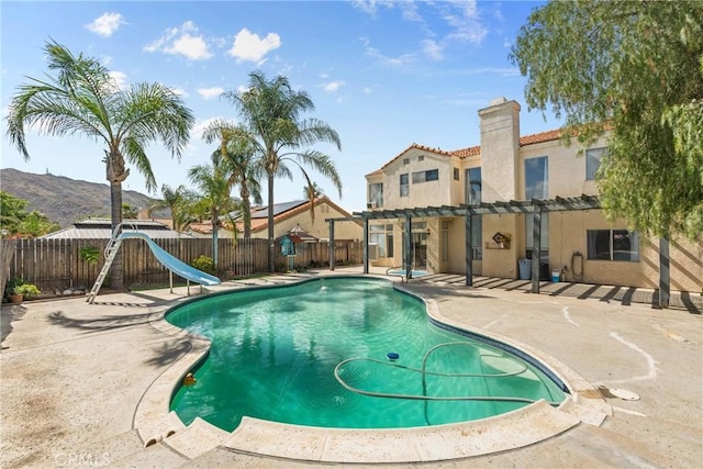 23633 Breezy Meadow Ct, Moreno Valley, CA 92557 - view of swimming pool with a water slide, a fenced backyard, a pergola, and a patio area