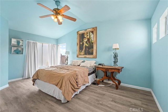 23633 Breezy Meadow Ct, Moreno Valley, CA 92557 - bedroom with wood finished floors, baseboards, lofted ceiling, and a ceiling fan