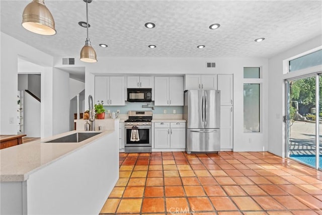 23633 Breezy Meadow Ct, Moreno Valley, CA 92557 - kitchen with stainless steel appliances, decorative light fixtures, white cabinetry, recessed lighting, and a sink