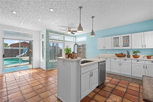 23633 Breezy Meadow Ct, Moreno Valley, CA 92557 - kitchen featuring stainless steel dishwasher, a sink, a ceiling fan, white cabinets, and light countertops