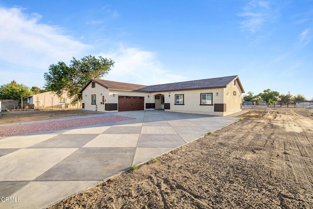 40719 E 171st St E, Lake Los Angeles, CA 93535 - ranch-style home with driveway, stucco siding, an attached garage, fence, and a tiled roof