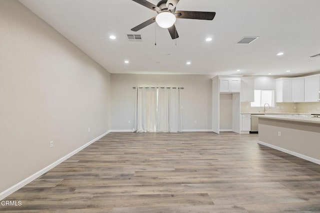 40719 E 171st St E, Lake Los Angeles, CA 93535 - unfurnished living room featuring ceiling fan, recessed lighting, baseboards, light wood-type flooring, and a sink
