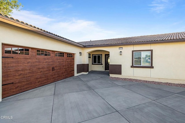 40719 E 171st St E, Lake Los Angeles, CA 93535 - view of front of house with a tile roof, stucco siding, and a garage