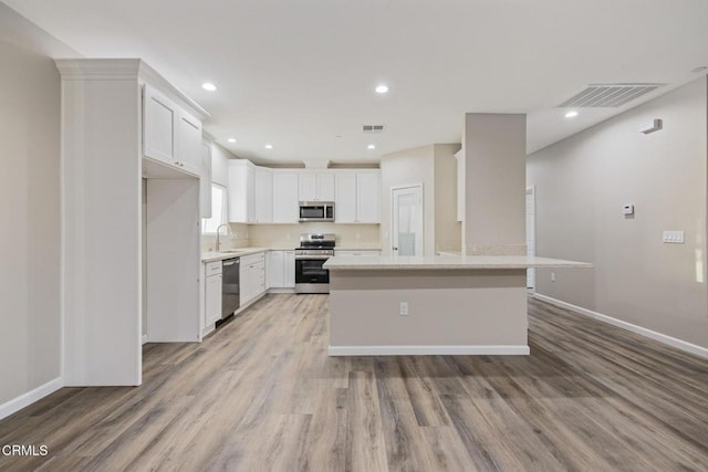 40719 E 171st St E, Lake Los Angeles, CA 93535 - kitchen featuring stainless steel appliances, light wood-style floors, a sink, white cabinetry, and recessed lighting