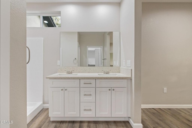 40719 E 171st St E, Lake Los Angeles, CA 93535 - full bath with wood finished floors, double vanity, a tile shower, and baseboards